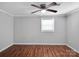 Simple bedroom featuring hardwood floors, fresh paint, and a window allowing natural light at 105 Strickland Ln, Bessemer City, NC 28016