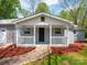 Inviting front porch with white railing and a dark-colored front door creates a welcoming entrance to this home at 105 Strickland Ln, Bessemer City, NC 28016