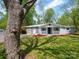Charming one-story home featuring a covered front porch and a well-maintained lawn with mature trees at 105 Strickland Ln, Bessemer City, NC 28016