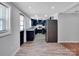 Eat-in kitchen with navy cabinets, granite countertops, stainless steel appliances and wood look floors at 105 Strickland Ln, Bessemer City, NC 28016