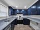Modern kitchen with navy cabinets, granite countertops, stainless steel appliances and wood look floors at 105 Strickland Ln, Bessemer City, NC 28016
