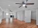 Open concept living room with hardwood floors, ceiling fan, and a view to the next room at 105 Strickland Ln, Bessemer City, NC 28016