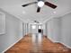 Spacious living room featuring a ceiling fan, hardwood floors, and freshly painted walls at 105 Strickland Ln, Bessemer City, NC 28016
