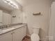 Neutral bathroom featuring white vanity, granite counters, and shower with curtain at 1052 Churchill Downs Ct # I, Charlotte, NC 28211