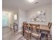 The dining room is naturally lit with a table, four chairs, and modern art at 1052 Churchill Downs Ct # I, Charlotte, NC 28211
