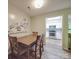Cozy dining room featuring a wooden table and chairs, with a view of the modern kitchen at 1052 Churchill Downs Ct # I, Charlotte, NC 28211