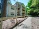 A charming condo building with multi-story balconies surrounded by trees at 1052 Churchill Downs Ct # I, Charlotte, NC 28211