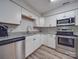 Modern kitchen equipped with stainless steel appliances, granite countertops, and white cabinets at 1052 Churchill Downs Ct # I, Charlotte, NC 28211