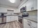 Updated kitchen features white cabinets, stainless steel appliances and granite countertops at 1052 Churchill Downs Ct # I, Charlotte, NC 28211
