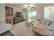 Bright living room with a sliding glass door leading to a balcony, and modern decor at 1052 Churchill Downs Ct # I, Charlotte, NC 28211