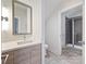 Well-lit bathroom featuring a quartz countertop, a modern vanity, and a glass enclosed shower at 1054 Kenilworth Ave, Charlotte, NC 28204