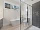 Modern bathroom with a soaking tub, glass-enclosed shower, and stylish tile at 1054 Kenilworth Ave, Charlotte, NC 28204