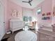 Charming Bedroom with a white crib, soft pink walls, natural light, and playful decor at 1054 Kenilworth Ave, Charlotte, NC 28204