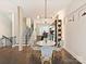 Cozy dining area with stylish chairs, modern lighting, and a view into the open kitchen at 1054 Kenilworth Ave, Charlotte, NC 28204