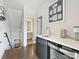 Chic wet bar with modern cabinetry, a mini-fridge, and a stylish sink for easy entertaining at 1054 Kenilworth Ave, Charlotte, NC 28204