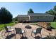 Backyard features a firepit with chairs, woodpile, and a meticulously maintained lawn at 109 Hunter Ct, Oakboro, NC 28129