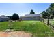 Large backyard features green grass, wood fence, and an inviting patio area, perfect for outdoor entertaining at 109 Hunter Ct, Oakboro, NC 28129