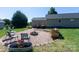 Backyard features a firepit with chairs, woodpile, and a lawn at 109 Hunter Ct, Oakboro, NC 28129