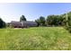 Expansive backyard with a patio, grill, and ample green space, offering ideal outdoor enjoyment opportunities at 109 Hunter Ct, Oakboro, NC 28129