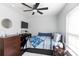 Cozy bedroom features ceiling fan, hardwood floors, a TV, and a comfortable bed at 109 Hunter Ct, Oakboro, NC 28129