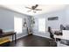 The bedroom has hardwood floors, large windows, with guitars and keyboards for musical inspiration at 109 Hunter Ct, Oakboro, NC 28129