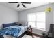 Bright bedroom with a window, ceiling fan, and a comfortable bed at 109 Hunter Ct, Oakboro, NC 28129