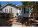 Inviting home entrance with steps, a white door, windows, and colorful shrubbery adding to curb appeal at 109 Hunter Ct, Oakboro, NC 28129