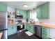 Well-lit kitchen with stainless steel appliances, subway tile backsplash, and butcher block countertops at 109 Hunter Ct, Oakboro, NC 28129
