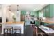 Charming kitchen features stainless steel appliances, butcher block countertops, and unique green cabinets at 109 Hunter Ct, Oakboro, NC 28129