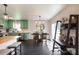Bright kitchen features green cabinetry, stainless appliances, and a stylish breakfast bar and a view to the dining area at 109 Hunter Ct, Oakboro, NC 28129