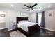 Comfortable main bedroom features a ceiling fan, hardwood floors, and soft, natural light at 109 Hunter Ct, Oakboro, NC 28129