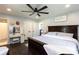 Comfortable main bedroom features a ceiling fan, hardwood floors, and a make-up vanity at 109 Hunter Ct, Oakboro, NC 28129