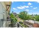 Relaxing balcony view overlooking lush greenery, city buildings, and a bright, sunny sky at 1101 W 1St St # 408, Charlotte, NC 28202