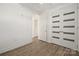 Bright bedroom featuring modern closet doors and neutral walls with luxury vinyl plank flooring at 1101 W 1St St # 408, Charlotte, NC 28202