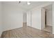 Bedroom featuring neutral walls and luxury vinyl plank flooring, with a view to another room at 1101 W 1St St # 408, Charlotte, NC 28202