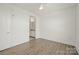 Bright bedroom with neutral walls and vinyl plank flooring, leading into a bathroom at 1101 W 1St St # 408, Charlotte, NC 28202