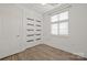 Bright bedroom showcasing a window with blinds and modern closet with luxury vinyl plank flooring at 1101 W 1St St # 408, Charlotte, NC 28202