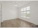 Bright bedroom with a large window featuring blinds and luxury vinyl plank flooring at 1101 W 1St St # 408, Charlotte, NC 28202