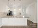 Bright kitchen with white cabinets, pendant lighting, and a spacious granite countertop island at 1101 W 1St St # 408, Charlotte, NC 28202