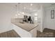 Modern kitchen featuring white cabinets, stainless steel appliances, and a large granite island at 1101 W 1St St # 408, Charlotte, NC 28202