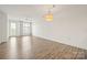 Spacious living room with hardwood floors, modern lighting, and large windows for natural light at 1101 W 1St St # 408, Charlotte, NC 28202