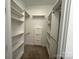 Walk-in closet featuring custom shelving, and carpeted floor at 1101 W 1St St # 408, Charlotte, NC 28202