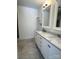 Bathroom with double vanity featuring white cabinets and marble countertops at 1101 W 1St St # 408, Charlotte, NC 28202