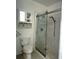Bathroom features a glass shower, tiled walls, a niche, and a cabinet above the toilet at 1101 W 1St St # 408, Charlotte, NC 28202