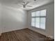 Bright bedroom featuring hardwood floors, a ceiling fan, and a window with natural light at 1101 W 1St St # 408, Charlotte, NC 28202