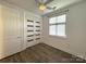 Neutral bedroom featuring wood floors, a ceiling fan, and window with blinds at 1101 W 1St St # 408, Charlotte, NC 28202