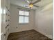 Bright bedroom features wood floors, a ceiling fan, window with blinds and a closet at 1101 W 1St St # 408, Charlotte, NC 28202