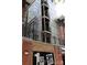 Modern condo building with multiple balconies and brick facade in the 3rd Ward Warehouse District at 1101 W 1St St # 408, Charlotte, NC 28202