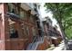 Brick apartment building complex featuring balconies and awnings with a staircase leading up to the units at 1101 W 1St St # 408, Charlotte, NC 28202