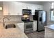 Well-lit kitchen featuring granite countertops, stainless steel appliances, and modern cabinetry at 1101 W 1St St # 408, Charlotte, NC 28202